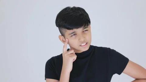 Indian cute boy thinking and finally he got an idea he is wearing black dress Stock Footage 159595457