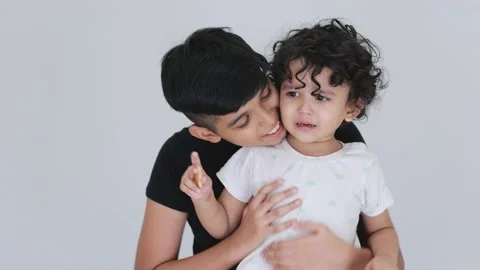 Indian cute boys crying and laughing same time big brother trying to stop sa Stock Footage 159595682