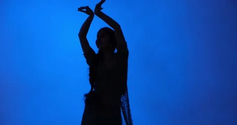 Indian Dancer's Silhouette on Blue background in Traditional Sari Video stock 242528828