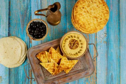 Indian dinner table with pita bread, hummus and olives. Stock Photos