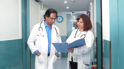 Indian doctors discuss reports documents of patient at hospital, Medical st.. Stock Footage 278305675