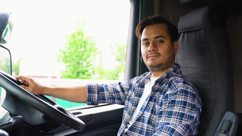Indian driver in cabin of big modern truck. Right hand drive car Stock Footage 251832938