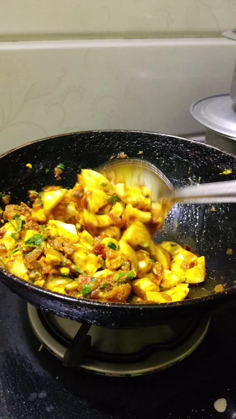Indian Egg Cooking Process with Boiled Eggs Fresh Coriander and Masala Stock Footage 338018500