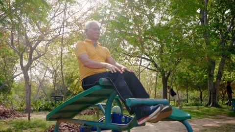 Indian Elderly man Performing abs exercise Outdoors in morning sunlight. Stock Footage 249941784