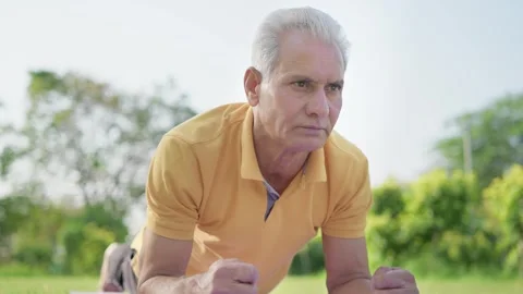 Indian Elderly Man Working out in open Outdoor Garden in morning daylight Stock Footage 247998456