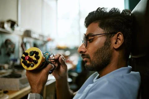 Indian Engineer Assembling Robotic Device in Tech Lab Stock Photos