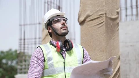 Indian engineer checking adrawing at construction site. Stock-Footage 162014759