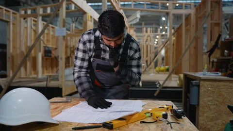 Indian engineer drafting modular home plan at construction site Stock Footage 301827443