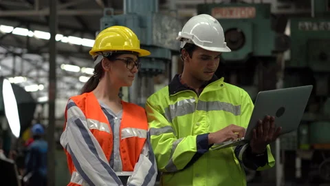 Indian Engineer in Hard Hats and Inspector woman talking and inspect machines Stock Footage 139818867