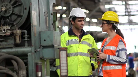 Indian Engineer in Hard Hats and Inspector woman talking and inspect machines Stock Footage 139819351