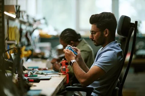 Indian Engineer Inspecting Circuit Board in Hardware Workshop Stock Photos