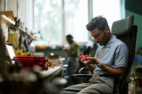 Indian Engineer Inspecting Electronic Hardware in Tech Workshop Stock Photos