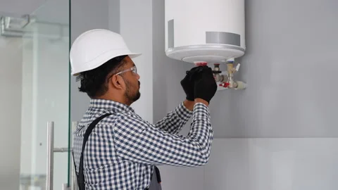 Indian engineer installing a natural gas boiler at home or office Stock Footage 279872938