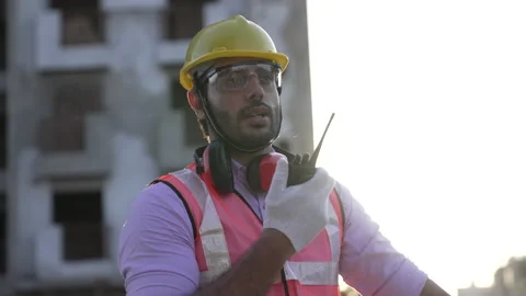 Indian engineer operate with radio talk to control work at construction. Vídeo Stock 161815309