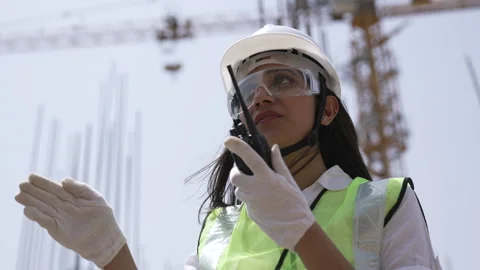 Indian engineer operate with radio talk to control work at construction. Video stock 162017510