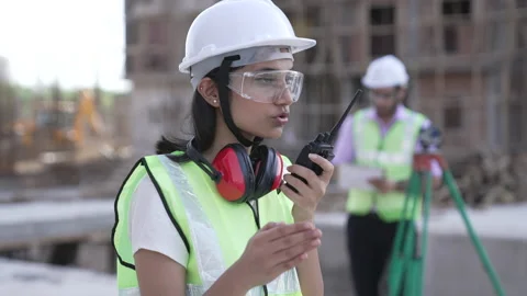 Indian engineer operate with radio talking to control work at construction. Video stock 161810042