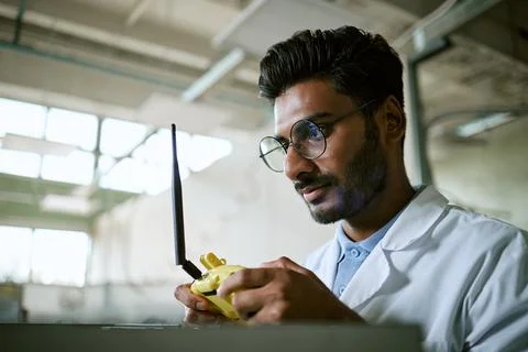 Indian Engineer Operating Remote Controller in Modern Laboratory Stock Photos