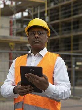 Indian engineer posing holding a digital tablet Stock Photos