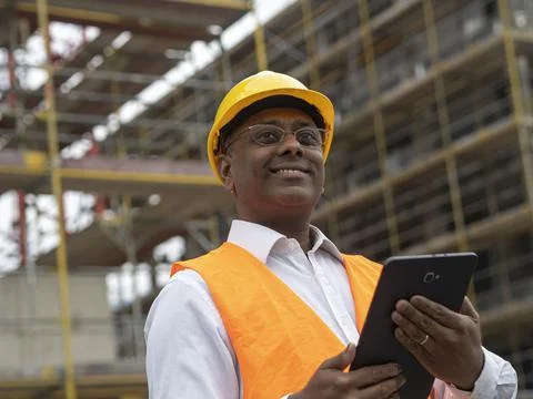Indian engineer posing holding a digital tablet 스톡 사진