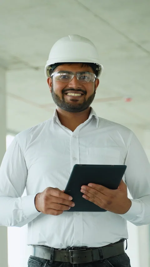 Indian engineer reviewing construction project data with tablet on-site Stock Footage 285683111