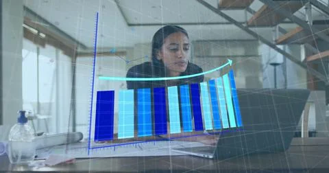Indian engineer studying laptop and blueprints in home office, with pump bottle, Stock Photos