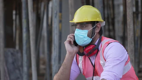 Indian engineer talking on smartphone to control work at construction. 스톡 동영상 161815488