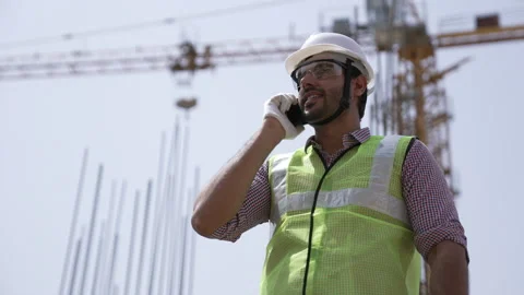Indian engineer talking on smartphone to control working at construction. Video stock 162016466