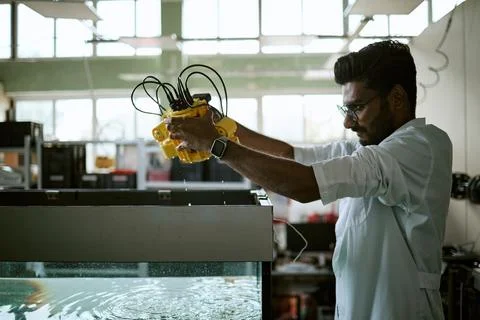 Indian Engineer Testing Underwater Robot Device in Laboratory Stock Photos