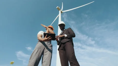 Indian engineer in uniform and helmet using tablet during meeting with african Stock Footage 170555977