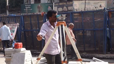 Indian engineer uses tacheometer at construction site Stock Footage 83634093