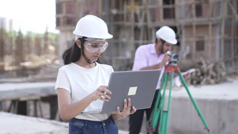 Indian Engineer using wireless devices to check plan at construction. Видео 161808606