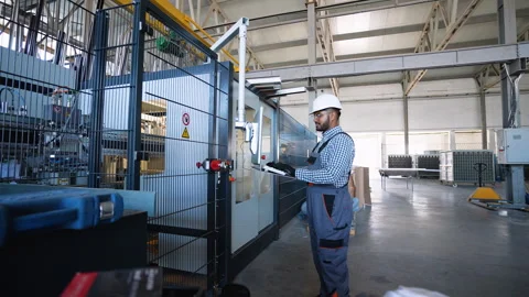 Indian engineer working at programmable CNC machine in factory industries Stock Footage 282999305