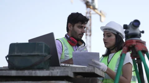 Indian engineers on Construction Site using papers and Looking at laptop 動画素材 161812605