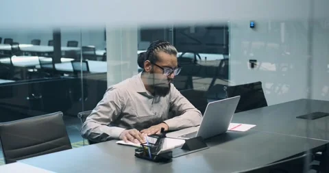 Indian Entrepreneur Taking Notes on Papers in Office Stock Footage 250273864