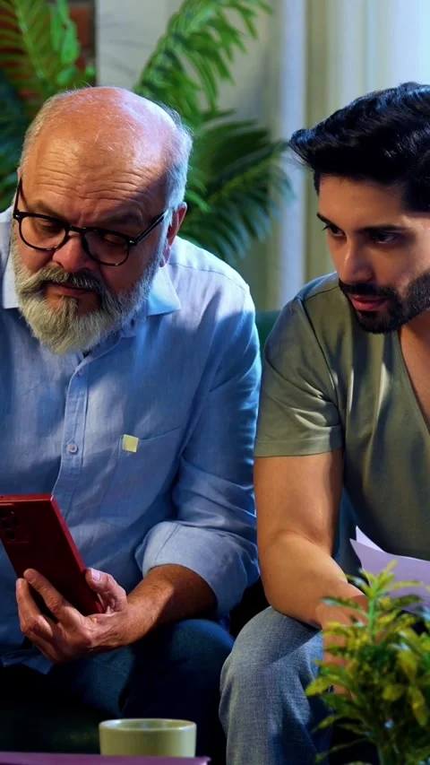 Indian experienced old dad grown son celebrating share trading profit indoors Stock-Footage 342757569