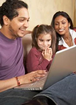 Indian family looking at laptop Stock Photos