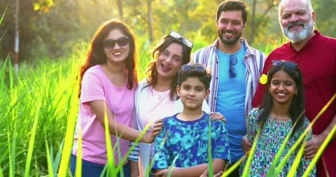Indian family playing cricket while camping outdoors, sharing laughs and fun Stock Footage 342840655