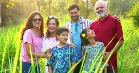 Indian family playing cricket while camping outdoors, sharing laughs and fun Stock Footage 342840670