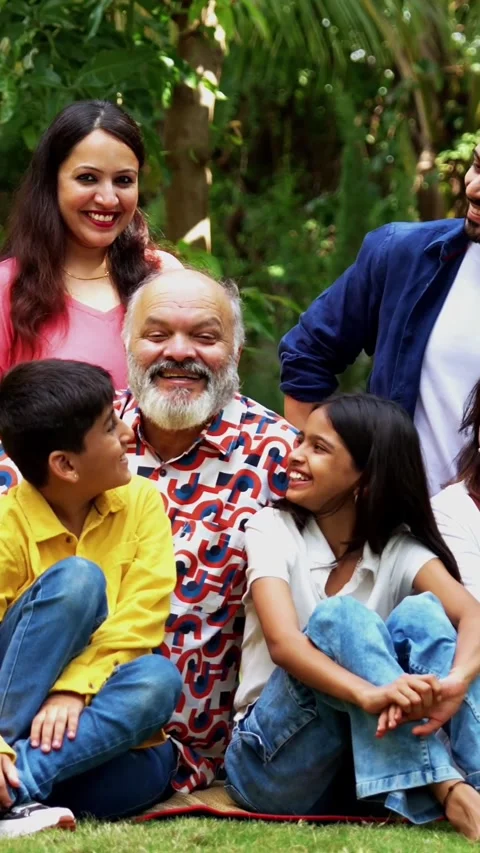Indian family of three generations bonding happily outdoors, Sitting on lawns Stock Footage 342839136