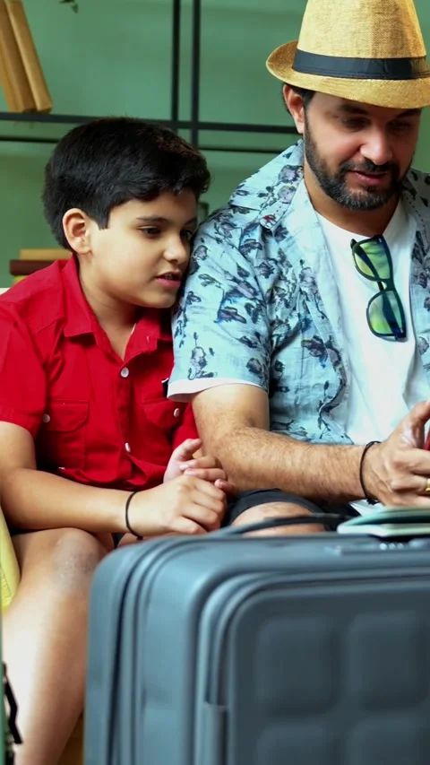Indian Family Using Smartphone for Mobile Web Check-in at Home Stock-Footage 342718265