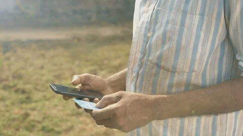 An Indian farmer making payment using Credit or Debit card, India Stock Footage 90107983