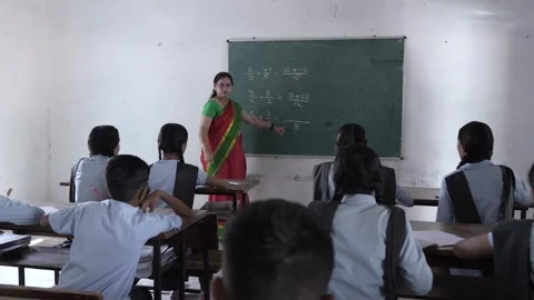 Indian female math teacher writes with chalk on the blackboard teaching sum.. Stock Footage 273547876
