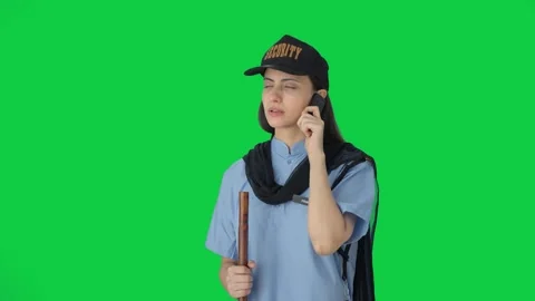 Indian female security guard talking to someone on call Green screen Stock Footage 250265049