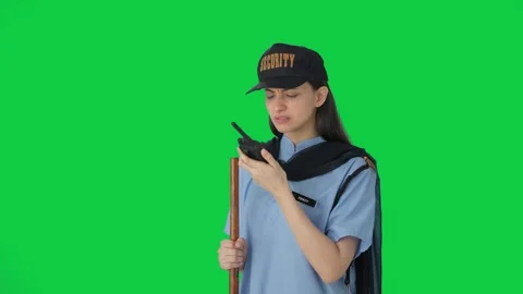Indian female security guard talking through walkie talkie Green screen Stock Footage 250265077