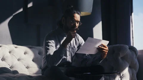 Indian financial analyst reviewing documents, monitoring stock market indexes Stock Footage 316837533