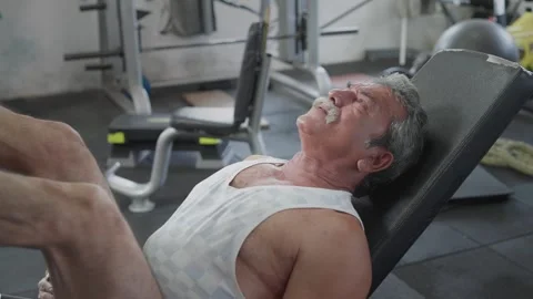 Indian fit aged man using bench press machine in a modern gym Stock Footage 341857087