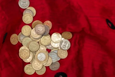 Indian five and ten rupee coins are kept in a red cloth Stock Photos