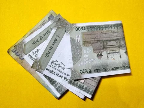 Indian five hundred rupee notes on the yellow background Stock Photos