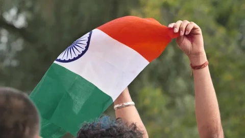 Indian flag held high, symbolizing patriotism and national pride Stock Footage 323361448