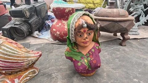 Indian Folk Doll Bust, Ceramic Pot and Vintage Camera at Outdoor Flea Market Stock Footage 346387830